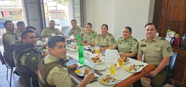 Carabineros de turno sonríen alrededor de la mesa de Nochebuena